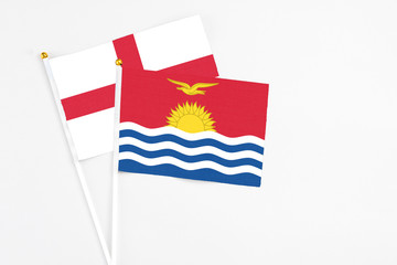 Kiribati and England stick flags on white background. High quality fabric, miniature national flag. Peaceful global concept.White floor for copy space.