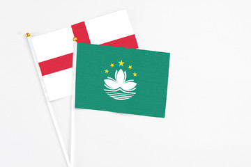 Macao and England stick flags on white background. High quality fabric, miniature national flag. Peaceful global concept.White floor for copy space.