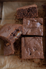 Homemade chocolate brownies on a white plate on a white wooden background
