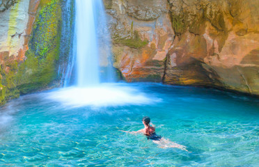 Girl in black bikini swiming in the sapadere pool - Sapadere canyon and beautiful turquoise waterfall - Antalya, Turkey 