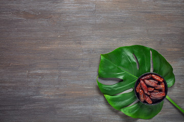 Dates fruits on plate on  light background. Top view. Copy space. Flat lay. Organic dried dates fruits.
