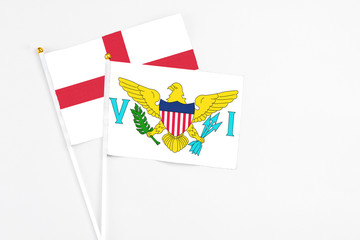 United States Virgin Islands and England stick flags on white background. High quality fabric, miniature national flag. Peaceful global concept.White floor for copy space.