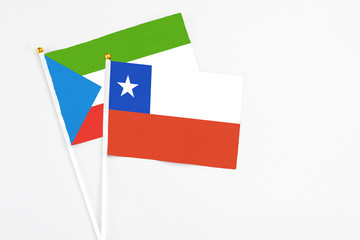 Chile and Equatorial Guinea stick flags on white background. High quality fabric, miniature national flag. Peaceful global concept.White floor for copy space.