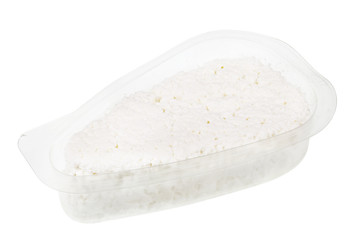 White soft curd  cheese in an open transparent plastic container isolated macro