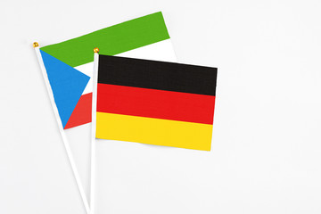 Germany and Equatorial Guinea stick flags on white background. High quality fabric, miniature national flag. Peaceful global concept.White floor for copy space.