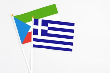 Greece and Equatorial Guinea stick flags on white background. High quality fabric, miniature national flag. Peaceful global concept.White floor for copy space.