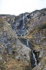 Fototapeta na wymiar Polikarya waterfall in the Caucasus mountains near Sochi, Russia. Cloudy day 26 October 2019