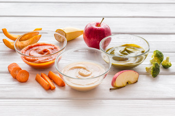 Vegetable and fruits puree for feed babies on white wooden background copy space