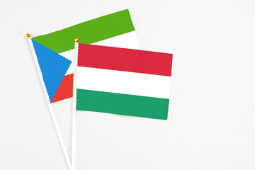 Hungary and Equatorial Guinea stick flags on white background. High quality fabric, miniature national flag. Peaceful global concept.White floor for copy space.