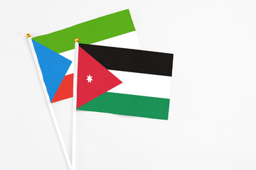 Jordan and Equatorial Guinea stick flags on white background. High quality fabric, miniature national flag. Peaceful global concept.White floor for copy space.