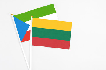 Lithuania and Equatorial Guinea stick flags on white background. High quality fabric, miniature national flag. Peaceful global concept.White floor for copy space.