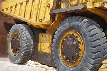 Fototapeta na wymiar Close up picture of a big yellow mining truck.