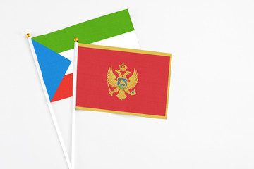 Montenegro and Equatorial Guinea stick flags on white background. High quality fabric, miniature national flag. Peaceful global concept.White floor for copy space.
