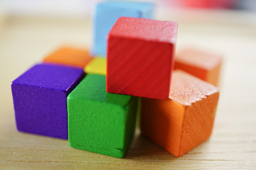 Wooden colorful block on wood background.