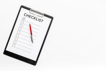Checklist and pen on white background top view copy space