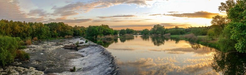 Beautiful view of the dam on the river at sunset