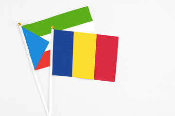 Romania and Equatorial Guinea stick flags on white background. High quality fabric, miniature national flag. Peaceful global concept.White floor for copy space.