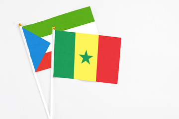 Naklejka premium Senegal and Equatorial Guinea stick flags on white background. High quality fabric, miniature national flag. Peaceful global concept.White floor for copy space.