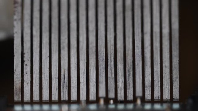 Abstract macro shot of the inside workings of an old music box.