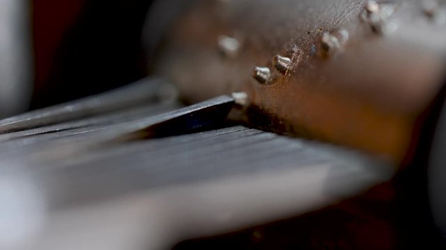 Macro shot of the detail on the moving parts of an old vintage music box.