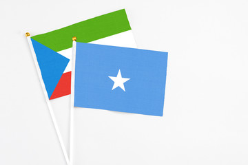 Somalia and Equatorial Guinea stick flags on white background. High quality fabric, miniature national flag. Peaceful global concept.White floor for copy space.