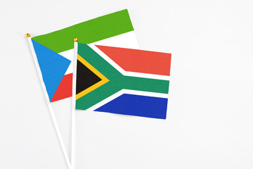 South Africa and Equatorial Guinea stick flags on white background. High quality fabric, miniature national flag. Peaceful global concept.White floor for copy space.