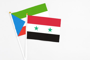 Syria and Equatorial Guinea stick flags on white background. High quality fabric, miniature national flag. Peaceful global concept.White floor for copy space.
