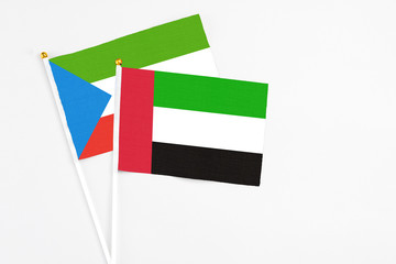 United Arab Emirates and Equatorial Guinea stick flags on white background. High quality fabric, miniature national flag. Peaceful global concept.White floor for copy space.