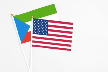 United States and Equatorial Guinea stick flags on white background. High quality fabric, miniature national flag. Peaceful global concept.White floor for copy space.