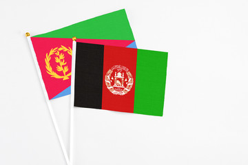 Afghanistan and Eritrea stick flags on white background. High quality fabric, miniature national...