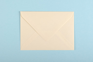 Paper envelope composition on blue background. Flat lay.