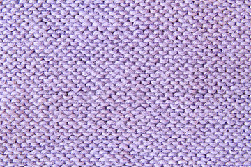 Violet or purple knitted textured background. Closeup