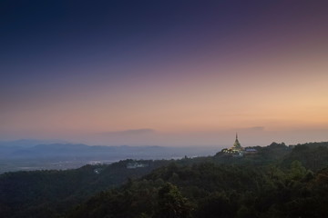 Mountain view evening of Crystal Pagoda or Chedi Kaew on top hill with purple sky background, twilight at Wat Tha Ton, Tha Ton, Fang, Chiang Mai, northern of Thailand.