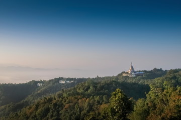 Fototapeta premium Mountain view morning of Crystal Pagoda or Chedi Kaew on top hill with blue sky background, sunrise at Wat Tha Ton, Tha Ton, Fang, Chiang Mai, northern of Thailand.