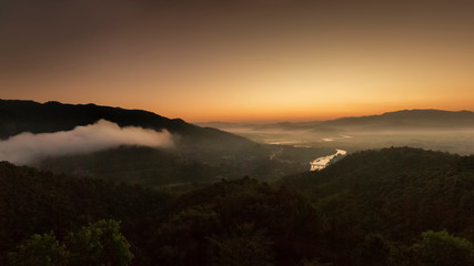 Mountain view panorama morning above Kok river around with sea of mist, mountain and yellow light in the sky background, sunrise at Wat Tha Ton, Tha Ton, Fang, Chiang Mai, Thailand.