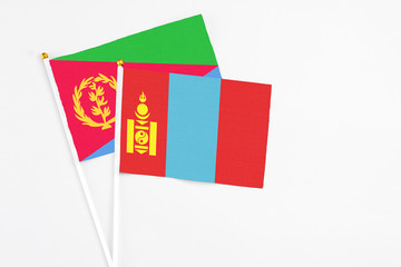 Mongolia and Eritrea stick flags on white background. High quality fabric, miniature national flag. Peaceful global concept.White floor for copy space.
