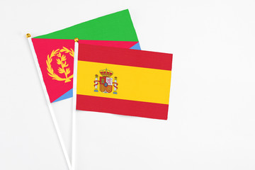 Fototapeta premium Spain and Eritrea stick flags on white background. High quality fabric, miniature national flag. Peaceful global concept.White floor for copy space.