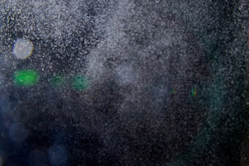Abstract dust explosion and flash with illumination on a black background