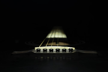 Black guitar on a dark background - obrazy, fototapety, plakaty