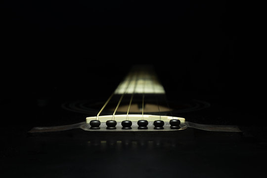 Black guitar on a dark background