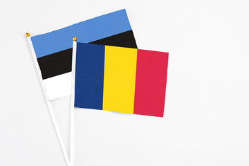 Chad and Estonia stick flags on white background. High quality fabric, miniature national flag. Peaceful global concept.White floor for copy space.