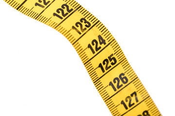 Close-up of a yellow measuring tape isolated on white - 125