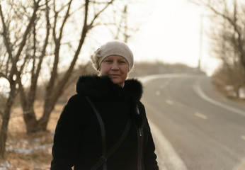 Winter portrait of a beautiful middle-aged woman in a fur coat.