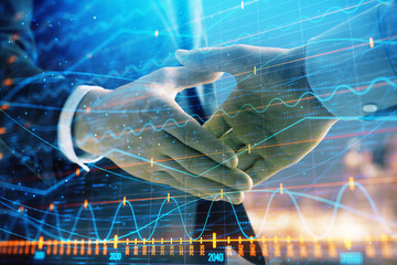 Double exposure of financial chart on cityscape background with two businessmen handshake. Concept of financial analysis and investment opportunities