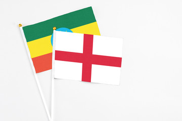 England and Ethiopia stick flags on white background. High quality fabric, miniature national flag. Peaceful global concept.White floor for copy space.