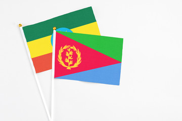 Eritrea and Ethiopia stick flags on white background. High quality fabric, miniature national flag. Peaceful global concept.White floor for copy space.