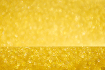 Golden glittering glowing bokeh background with blur.