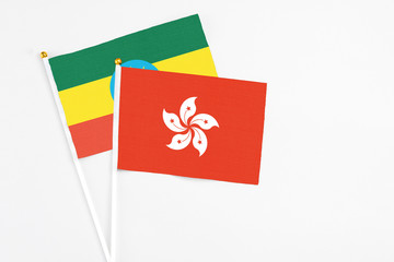 Hong Kong and Ethiopia stick flags on white background. High quality fabric, miniature national flag. Peaceful global concept.White floor for copy space.