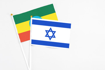 Israel and Ethiopia stick flags on white background. High quality fabric, miniature national flag. Peaceful global concept.White floor for copy space.
