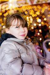 pretty little girl in front admiring Christmas decoration